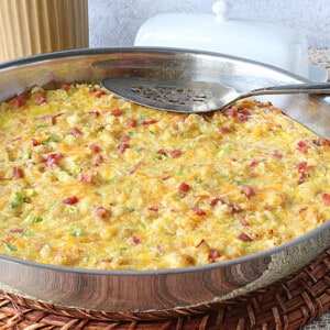 A Ham and Cheese Tater Tot Breakfast Bake in a silver skillet.