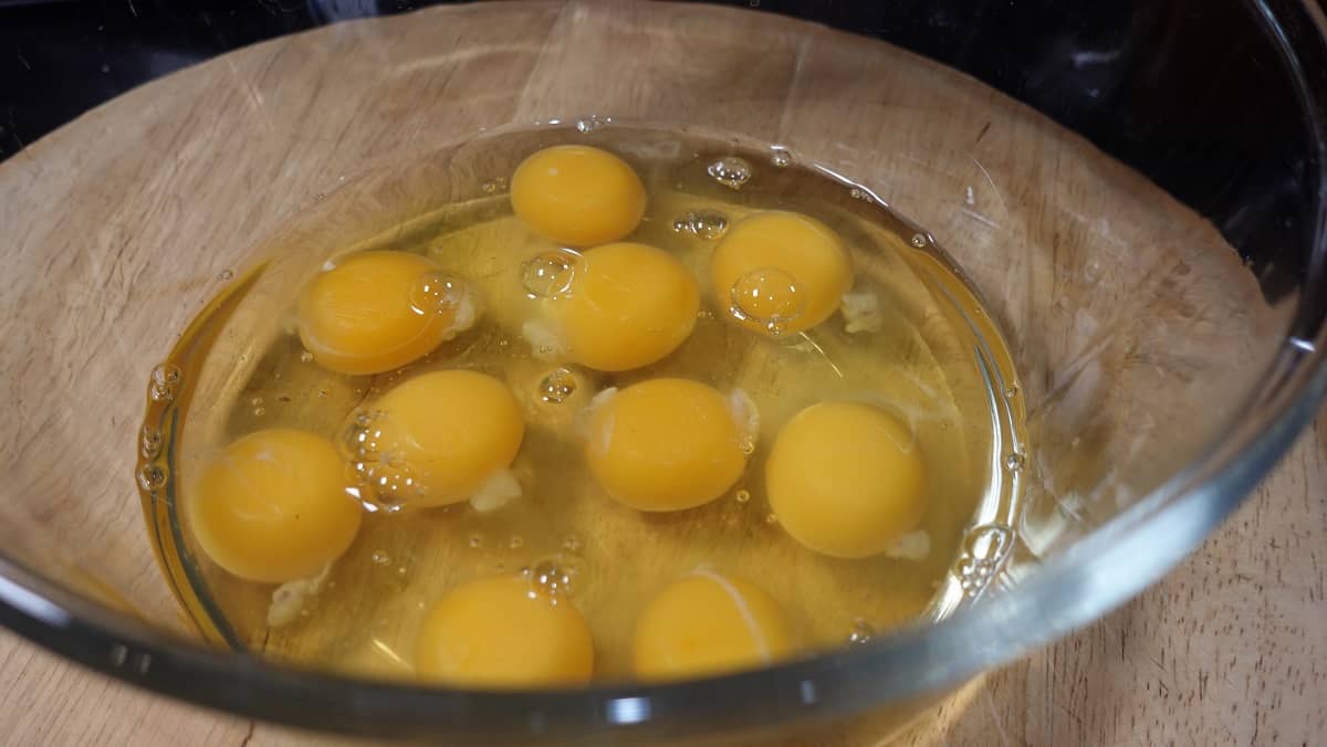 Eggs in a glass bowl waiting to be whisked.