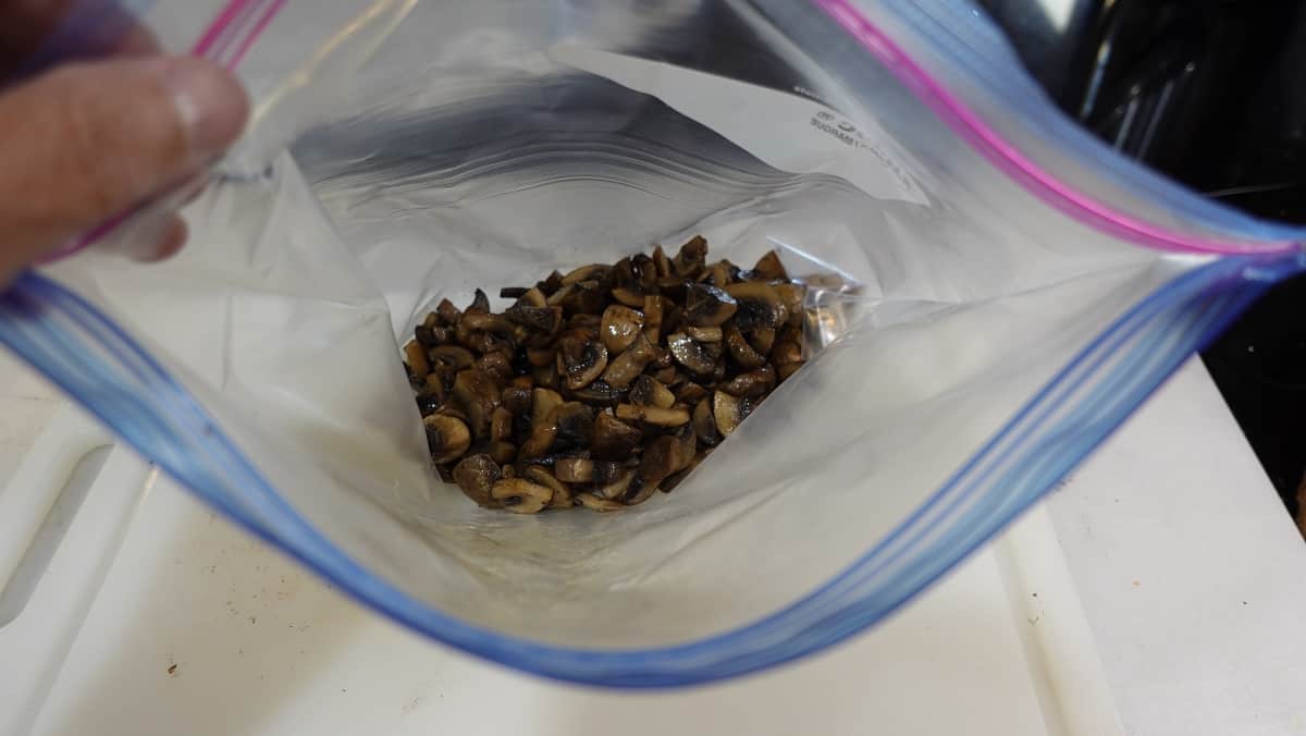 A view inside a zip loc bag that has sauteed mushrooms inside.