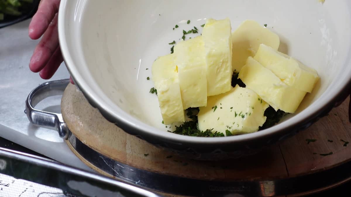 Butter and chopped herbs in a large bowl.