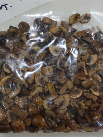 A bunch of Sauteed Mushrooms for Freezing in a plastic zip top bag.
