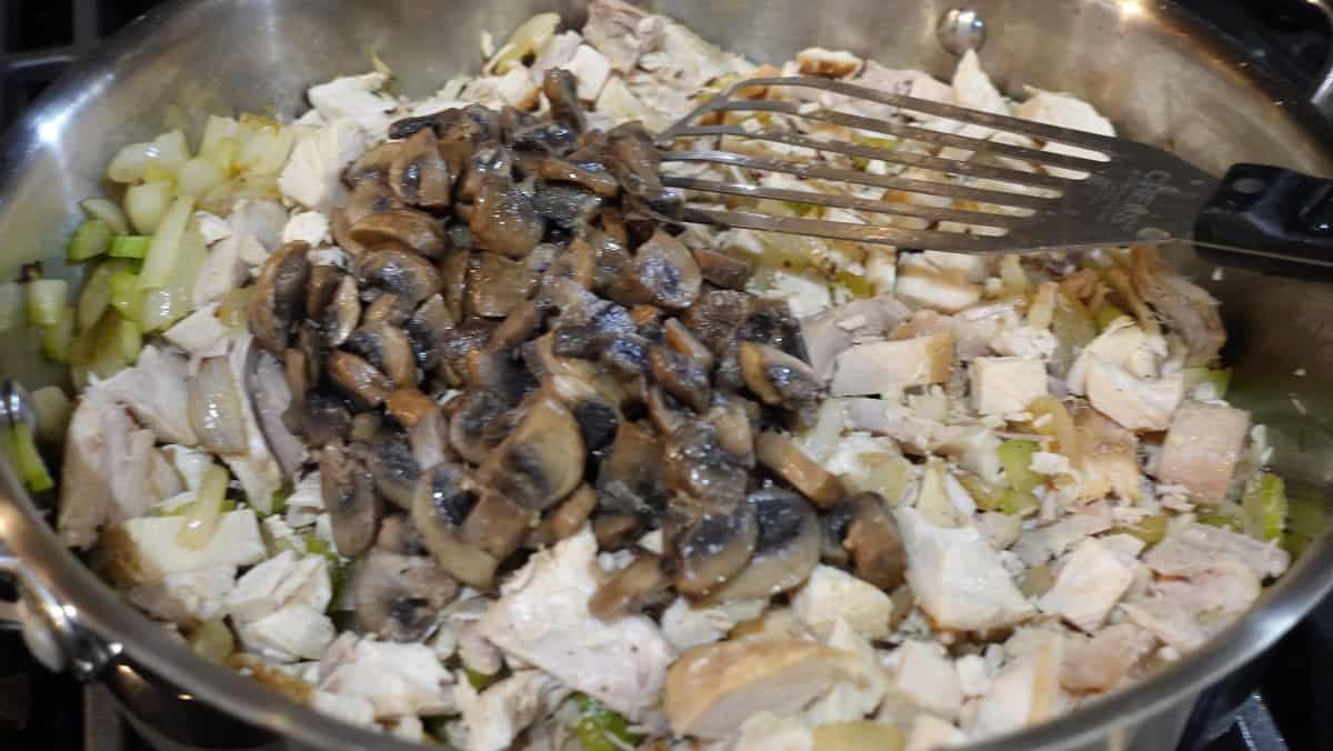 Leftover turkey and mushrooms in a skillet.