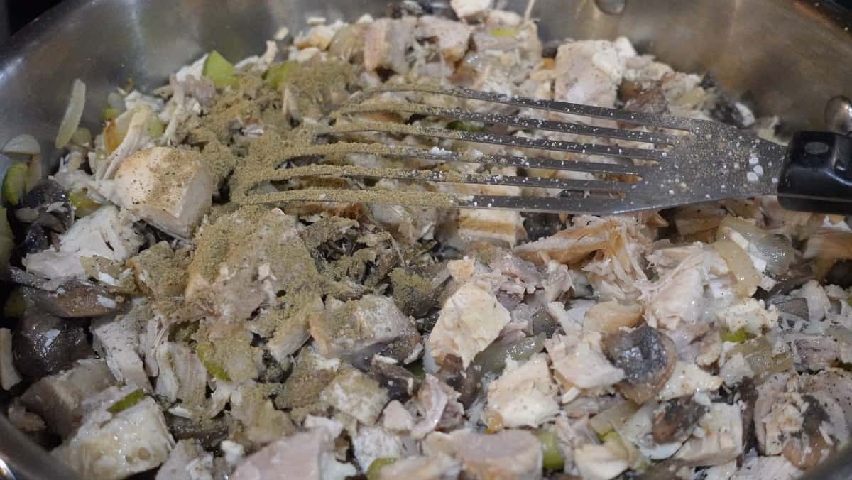 Add poultry seasoning to leftover turkey in a skillet.