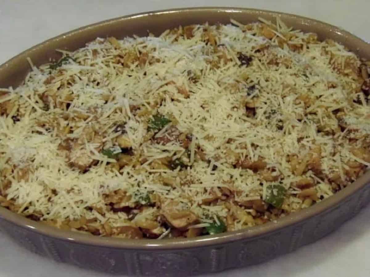 Parmesan cheese on top of a chicken and orzo casserole.