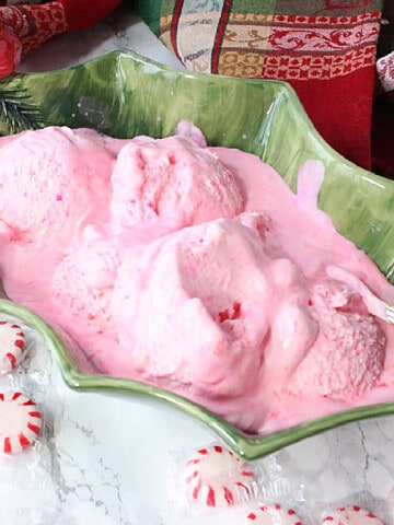 A serving of melting No-Churn Peppermint Schnapps Ice Cream in a green bowl.