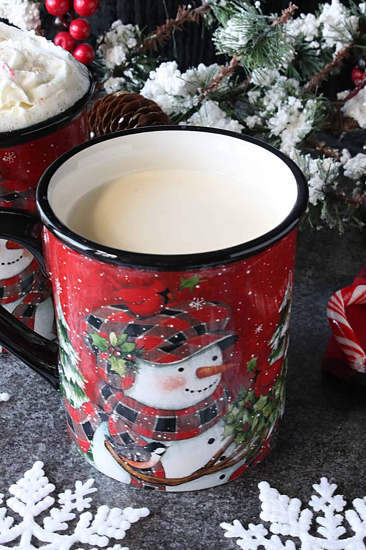 A cute red snowman mug filled with Peppermint White Hot Chocolate.