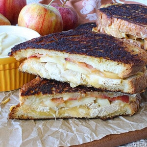 A turkey and smoked Gouda grilled cheese sandwich that's been cut in half.