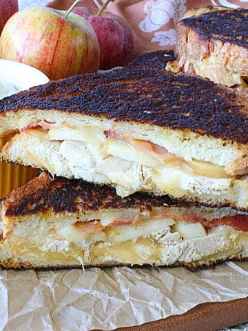 A turkey and smoked Gouda grilled cheese sandwich that's been cut in half.