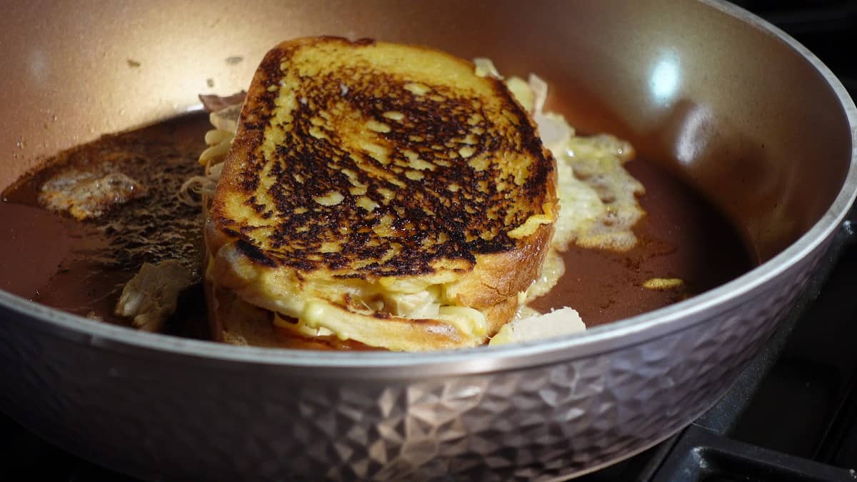 A browned Turkey and Smoked Gouda Grilled Cheese Sandwich in a skillet.