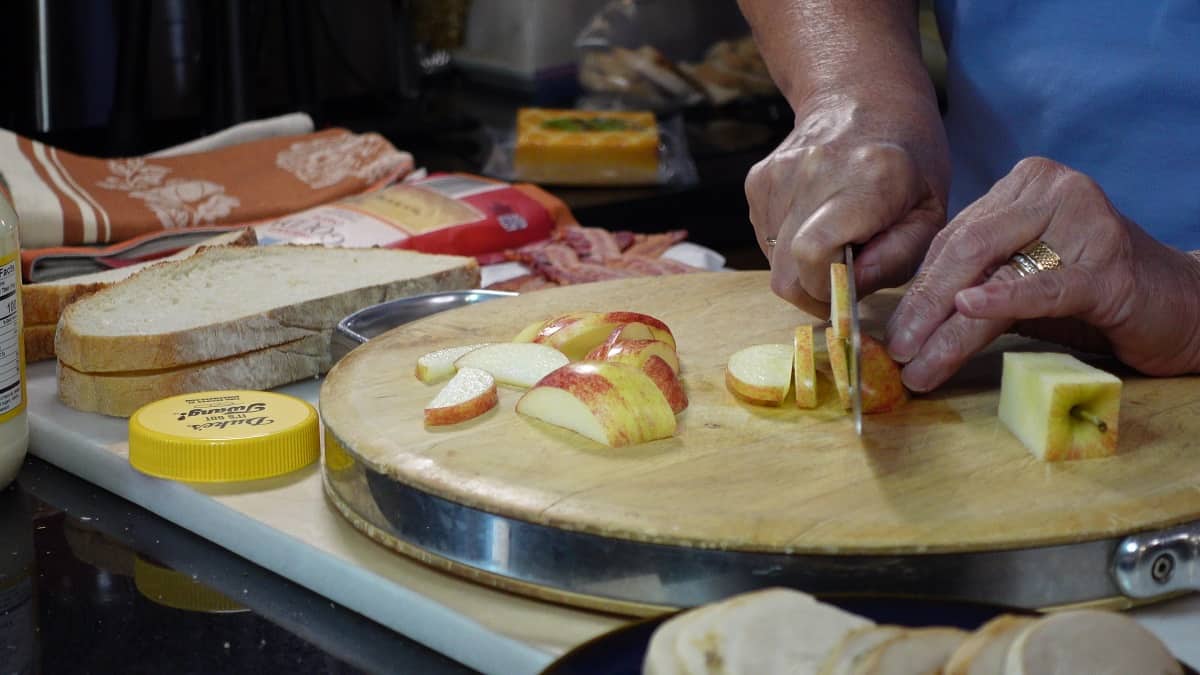 Apples being slices for a sandwich.