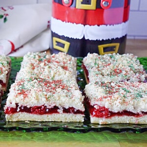 A few delicious looking slices of cherry Kringle Kuchen on a green glass plate.