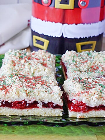 A few delicious looking slices of cherry Kringle Kuchen on a green glass plate.