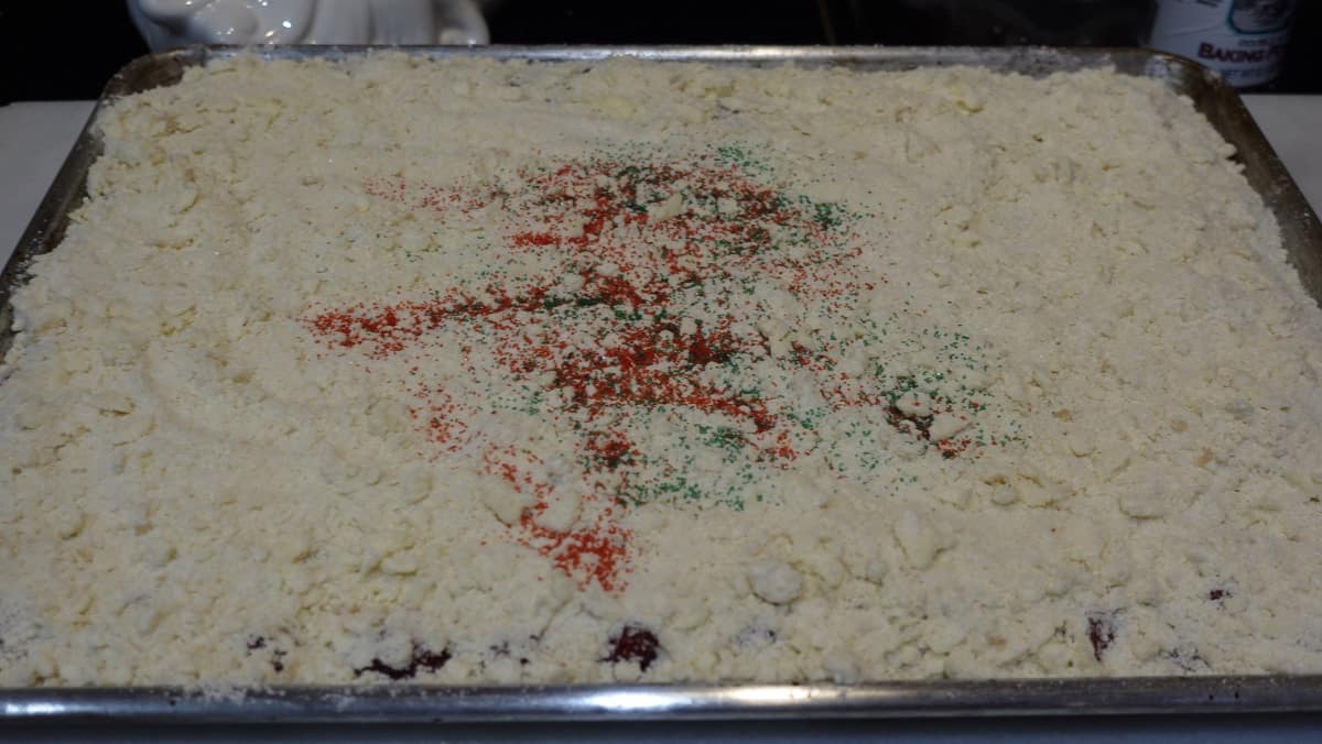 Red and green sanding sugar sprinkled on top of a fruit Kuchen.