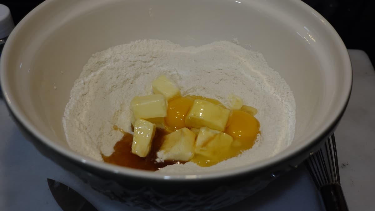 Flour, butter, eggs, and vanilla in a large bowl.