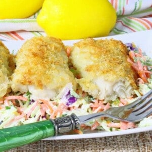 Three pieces of Potato Crusted Cod Fillets on a white plate with a fork.