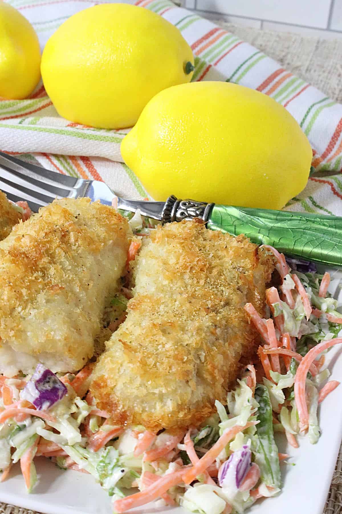 Golden brown Potato Crusted Cod on a bed of coleslaw.