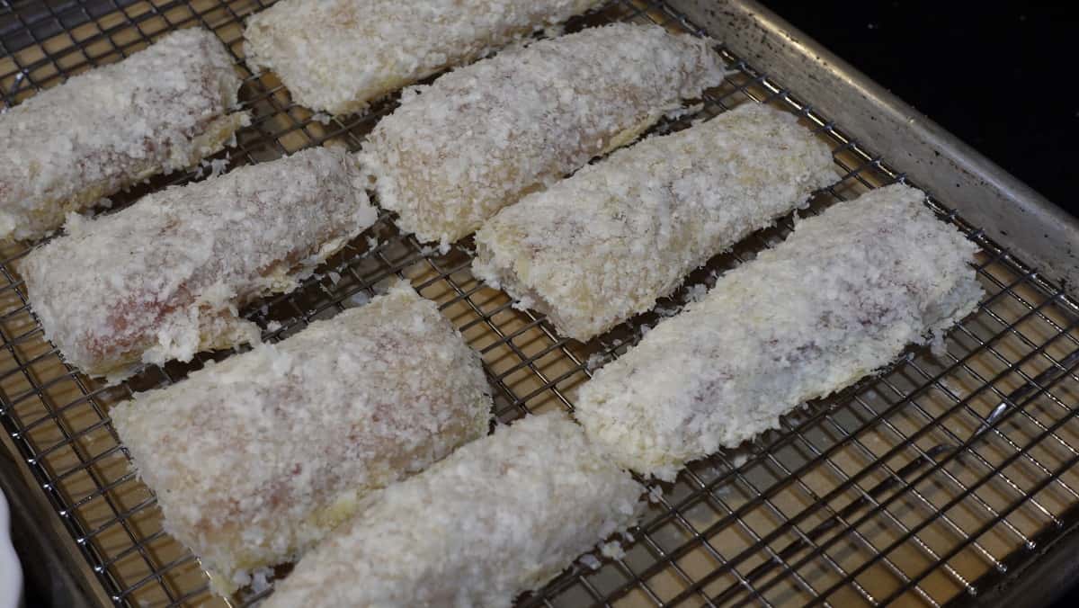 Cod dish fillets coated with potato flakes before baking.
