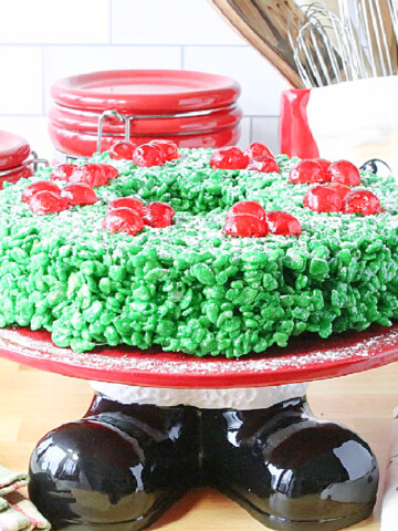 Cute Santa themed cake plate with a green rice krispies wreath on top.