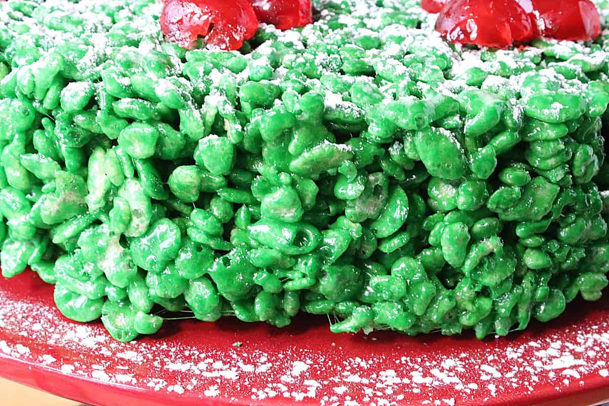 Green and red rice Krispies treats shaped into a wreath for Christmas.