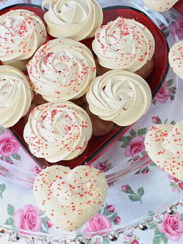 Almond Meringue Cookies on a glass plate.