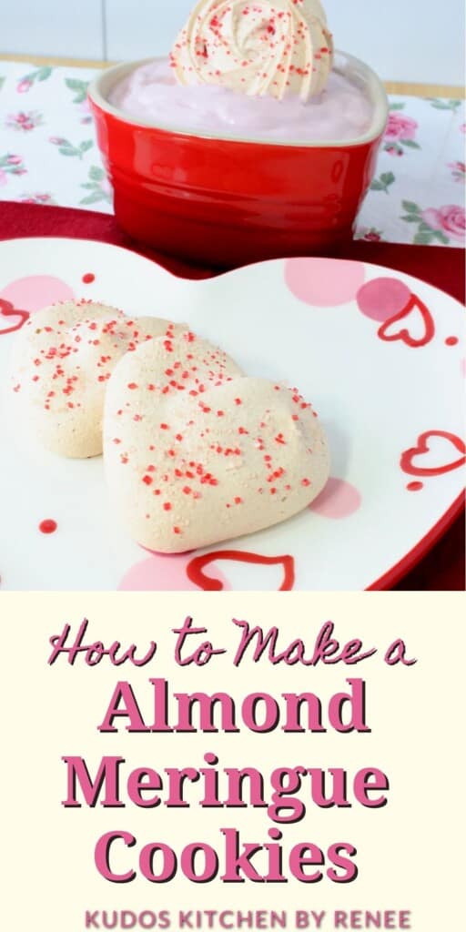 Two Almond Meringue Cookies on a heart plate with colored sugar sprinkles.