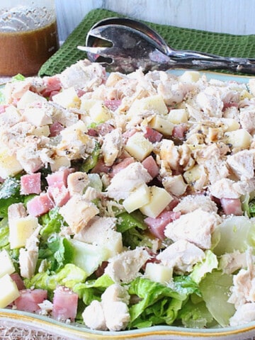 A Chicken Cordon Bleu Salad on a platter with cheese and meat.