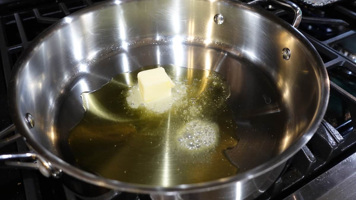 Oil and melting butter in a large skillet on a stovetop.