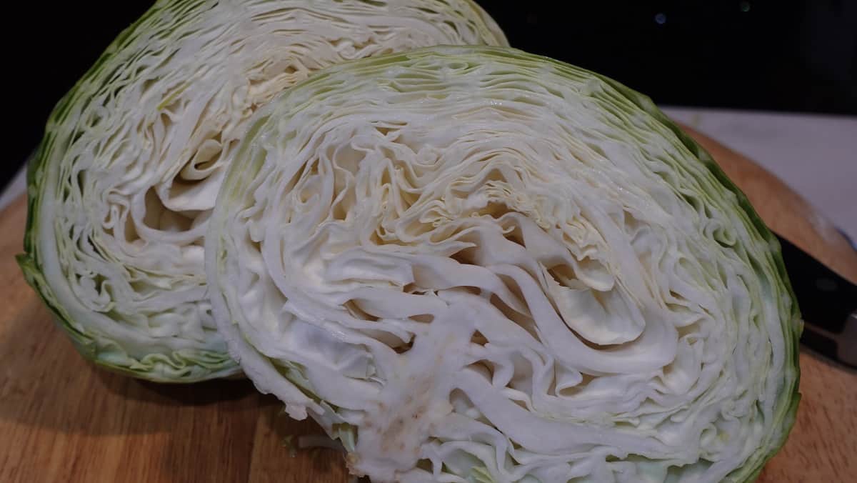 A view of the inside of a cabbage that's been sliced in half.