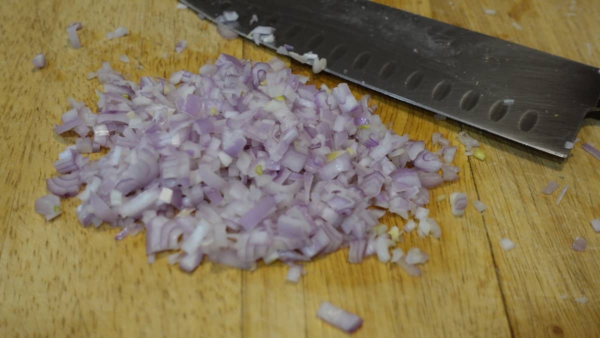 Minced shallots on a cutting board.