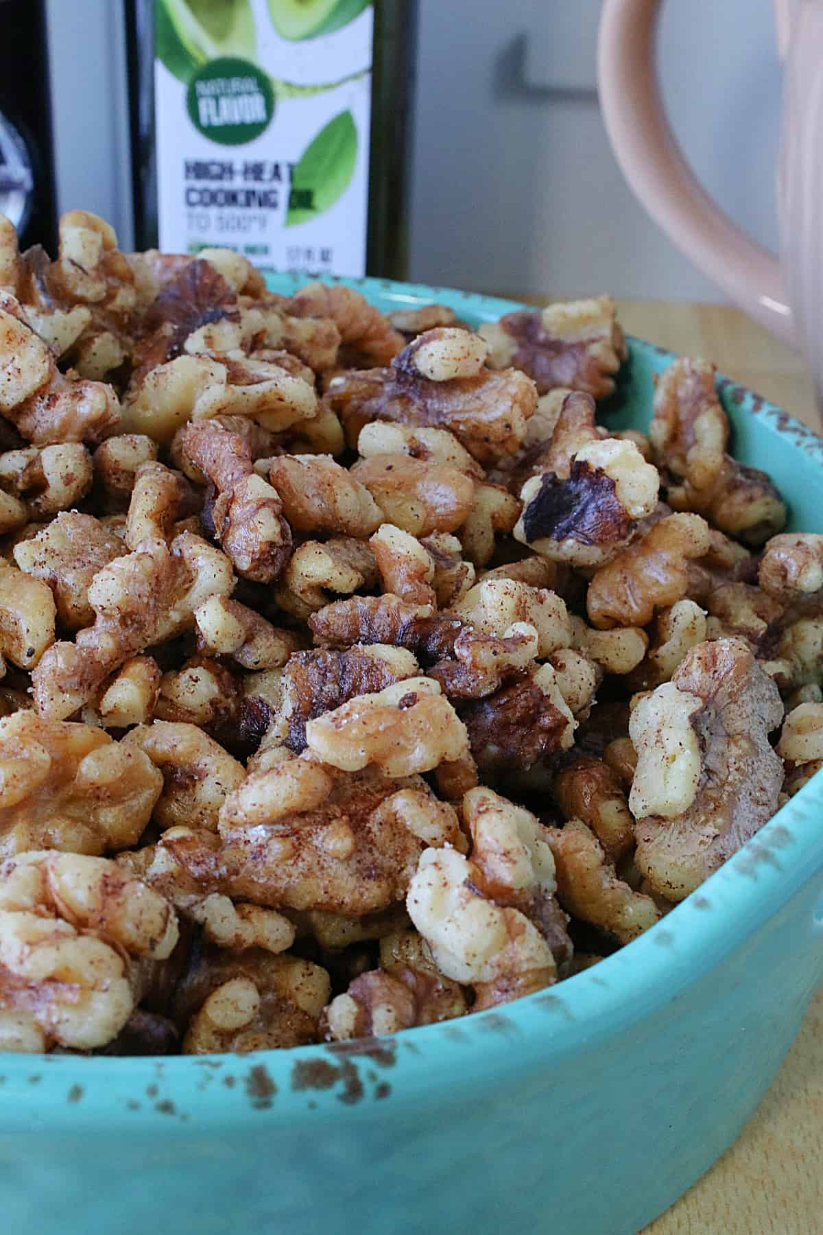 Cinnamon Roasted Walnuts in a blue ceramic dish.