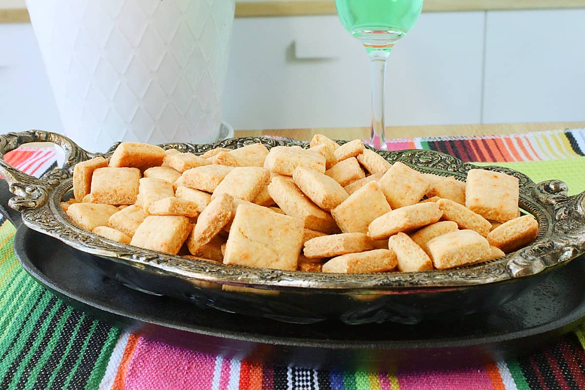 A colorful tablecloth with a dish of homemade crackers.