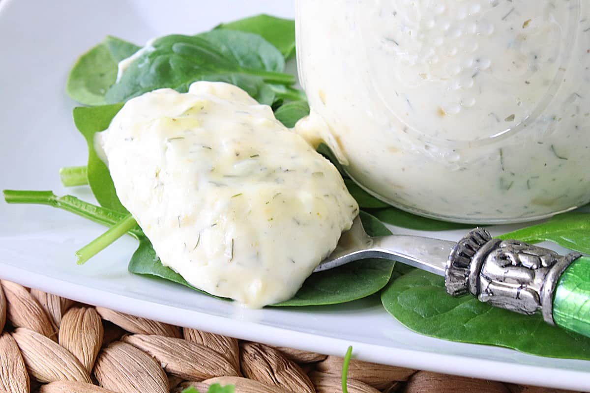 A fancy green spoon loaded with a big dollop of Homemade Dill Tartar Sauce.