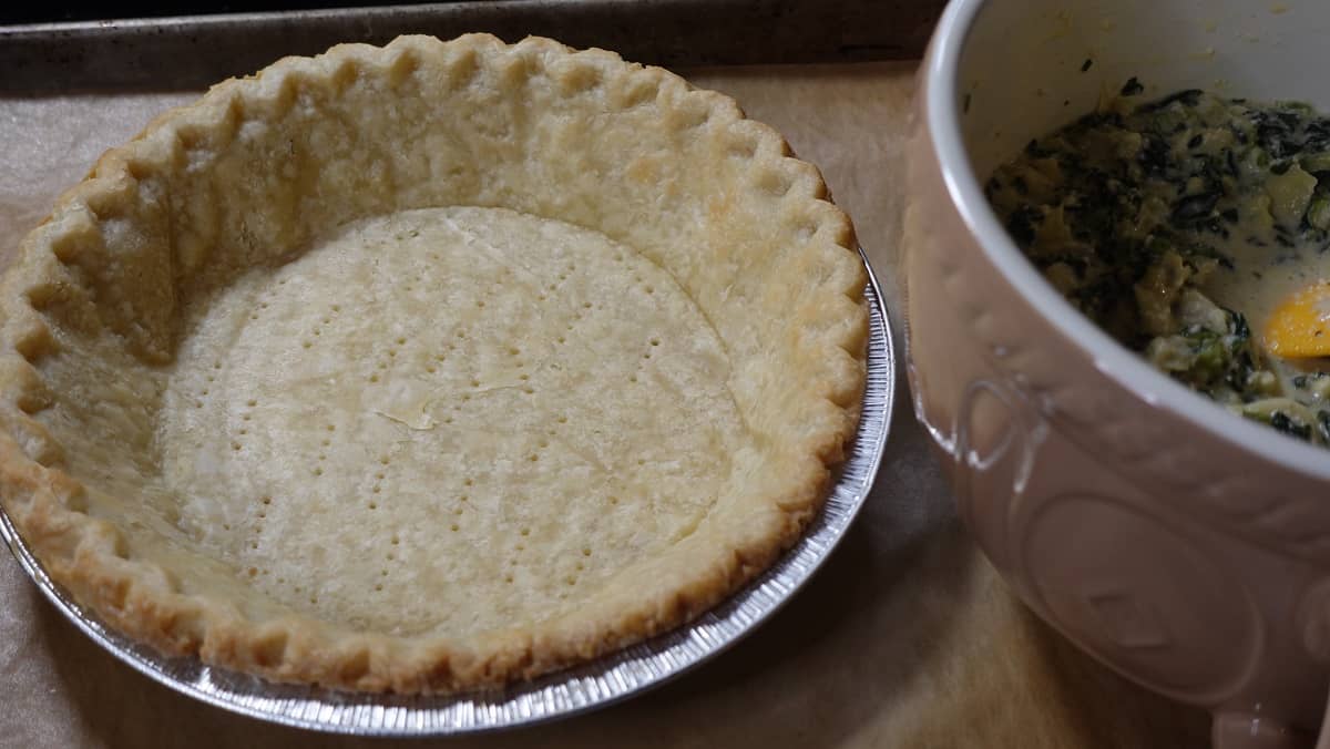 A blind baked pie crust without any bubbling of the crust.