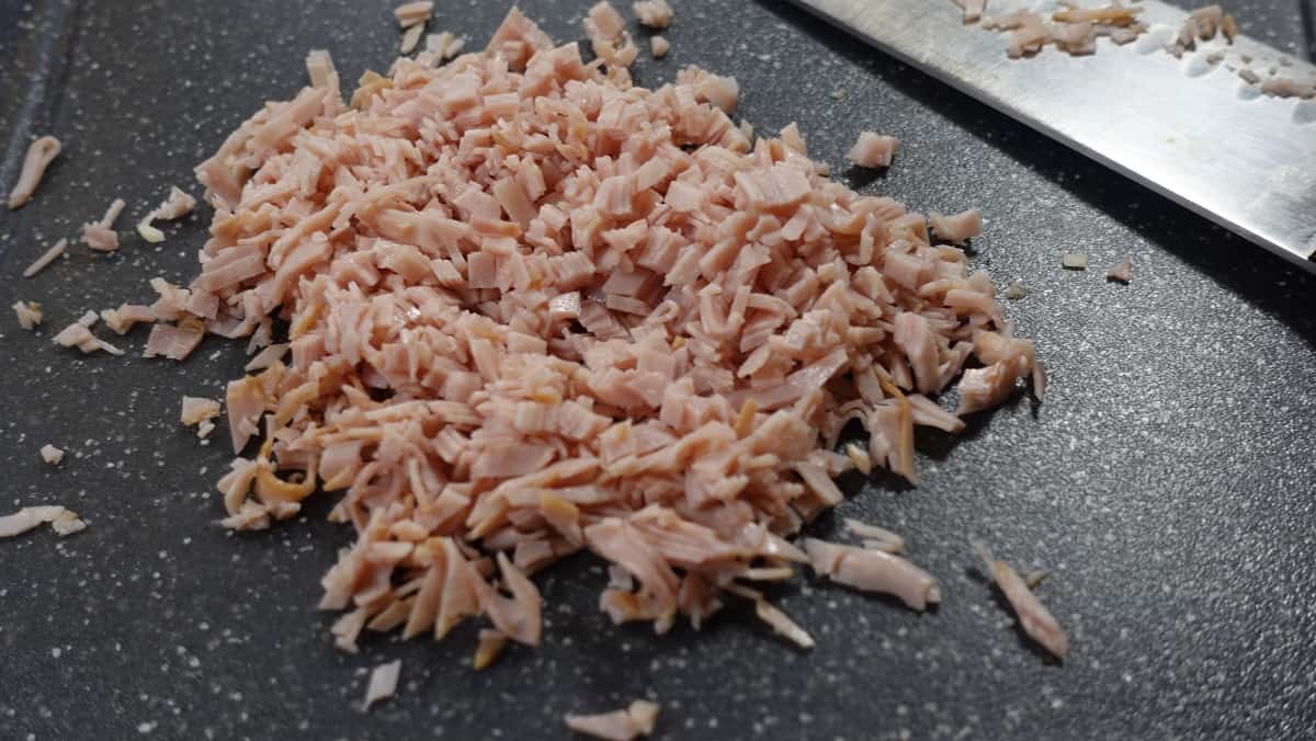 A pile of deli ham that has been diced into a very small size.