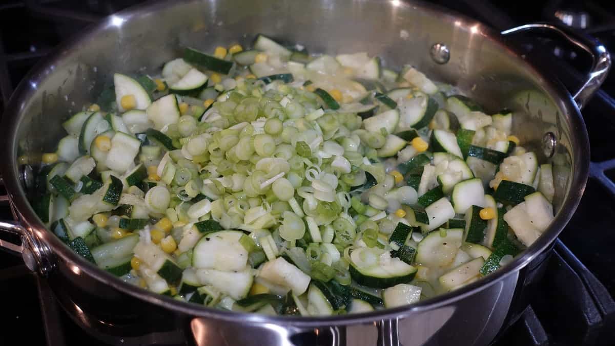 Scallions in a skillet with zucchini,