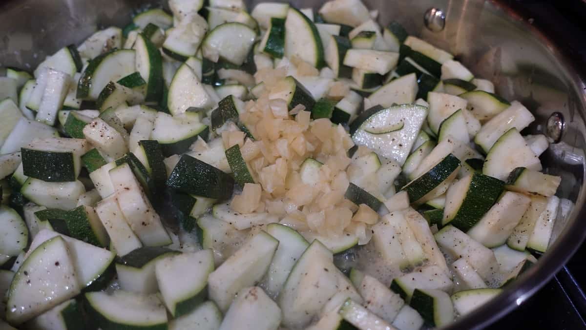 Chopped zucchini and garlic in a skillet.