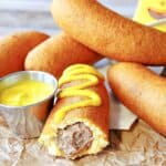 Bratwurst on a Stick with yellow mustard.