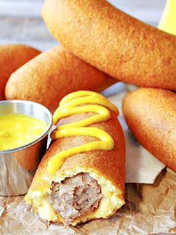 Bratwurst on a Stick with yellow mustard.