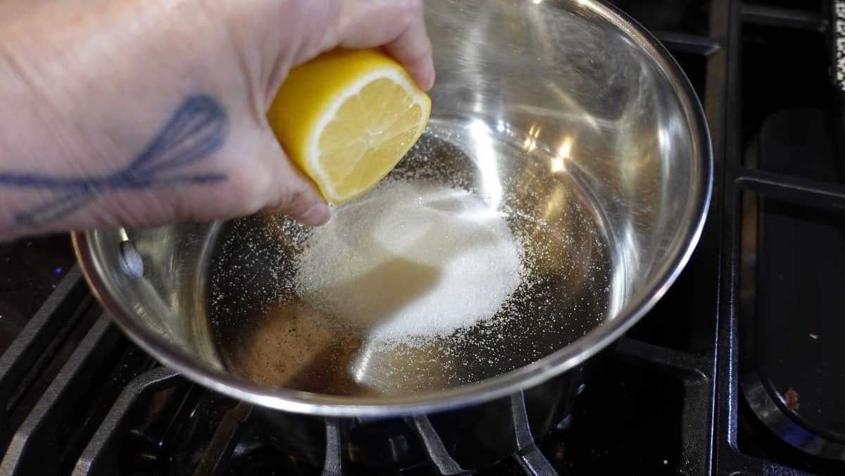 Lemon and sugar in a saucepan.