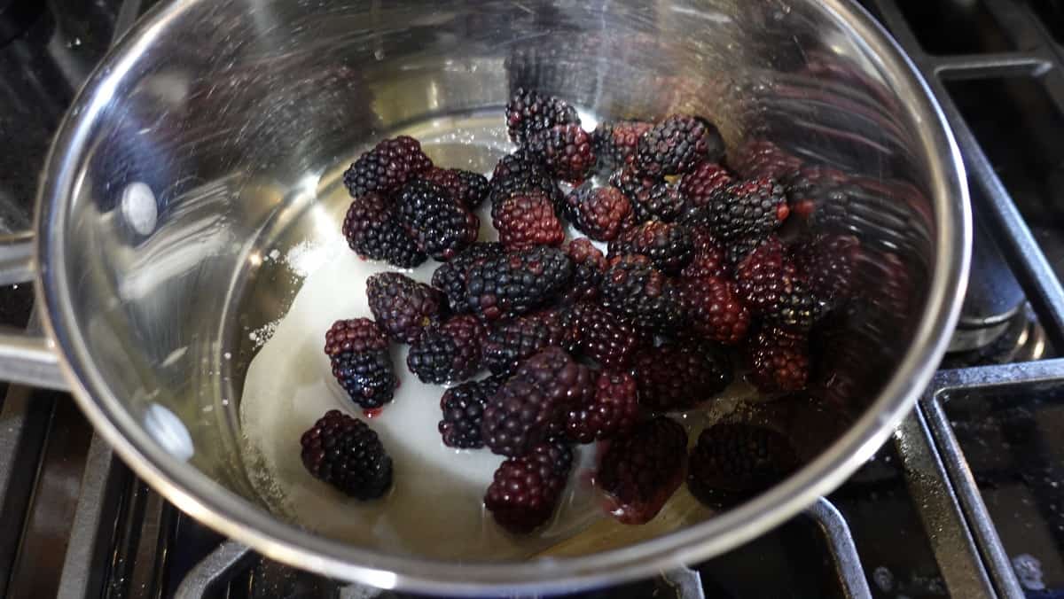 Sugar and berries in a saucepan.