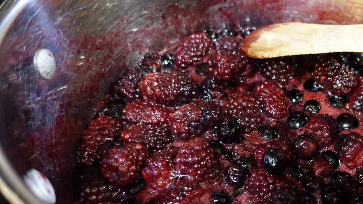 Cooked down berries in a saucepan.