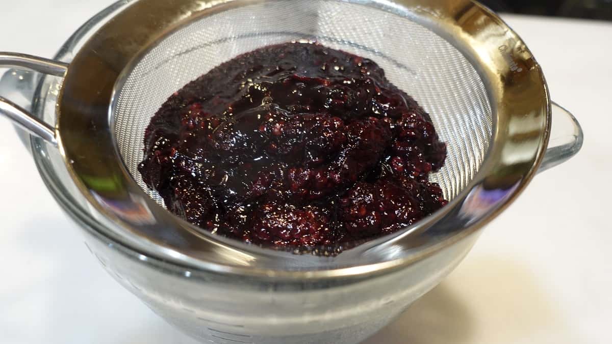 Cooked berries in a strainer.