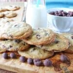 A stack of Chocolate Chip Espresso Bean Cookies with a glass of milk in the background.