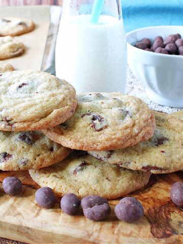 A stack of Chocolate Chip Espresso Bean Cookies with a glass of milk in the background.