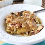 Panettone Bread Pudding with RumChata sauce in a white bowl.