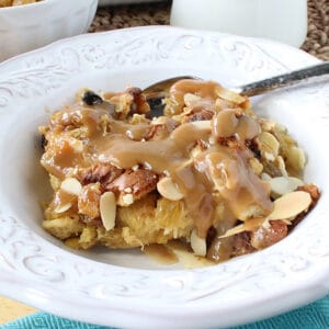 Panettone Bread Pudding with RumChata sauce in a white bowl.