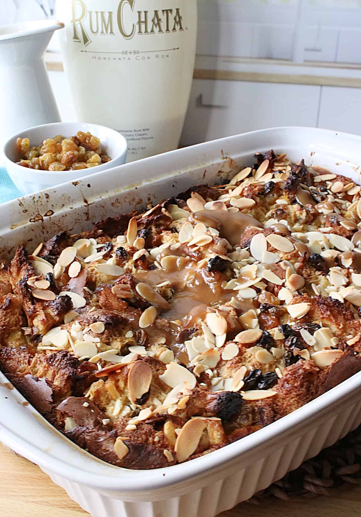 A rectangle casserole dish filled with Panettone Bread Pudding with RumChata Caramel Sauce.