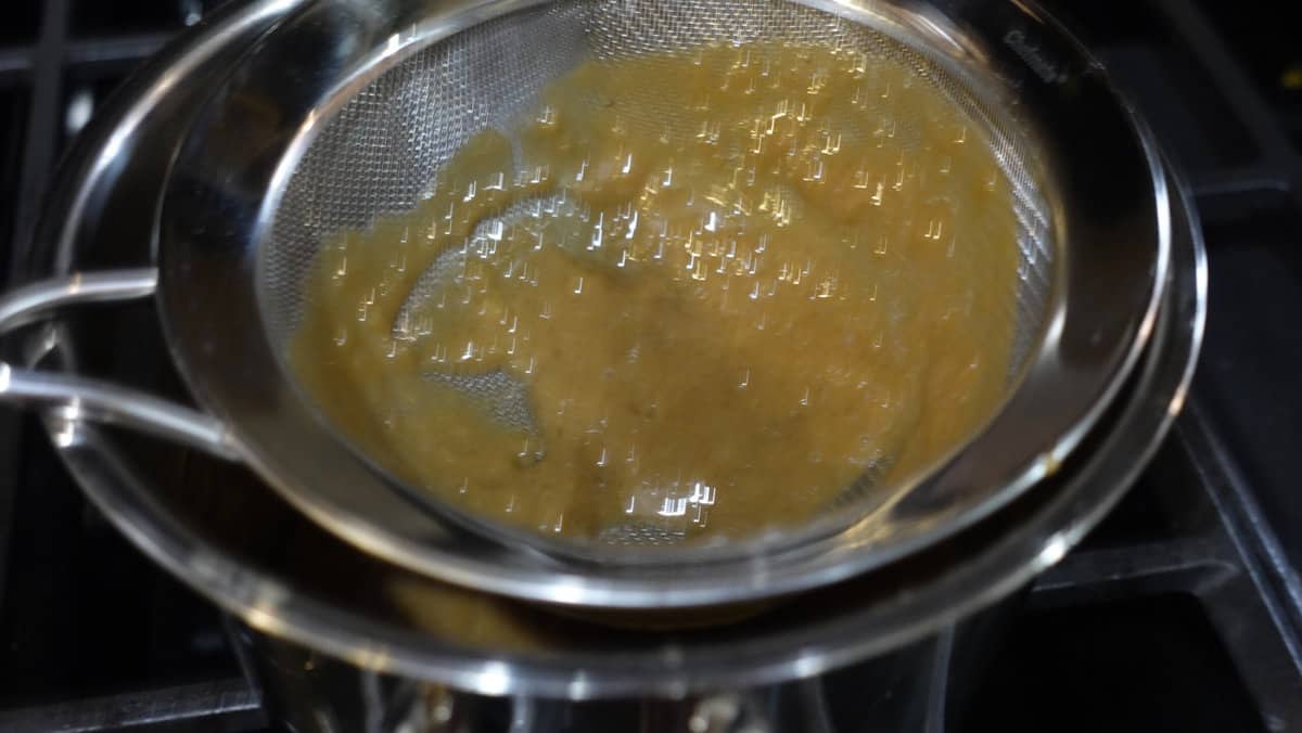 A rumchata caramel sauce in a strainer.