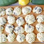 A baking sheet filled with Zucchini Ricotta Cookies that are drizzled with icing.
