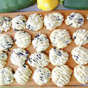 A baking sheet filled with Zucchini Ricotta Cookies that are drizzled with icing.